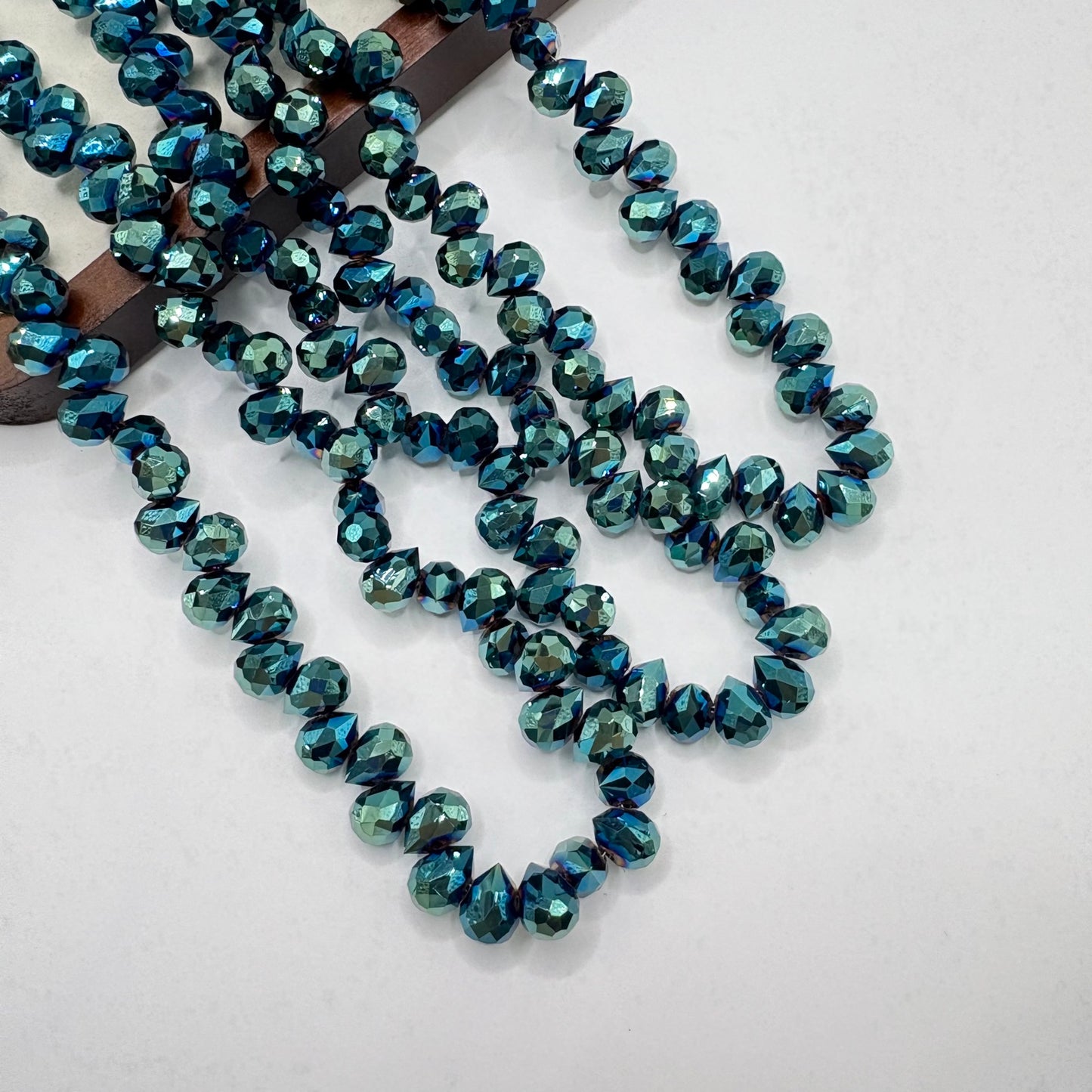 Teal 055 fine-cut teardrop bead strand