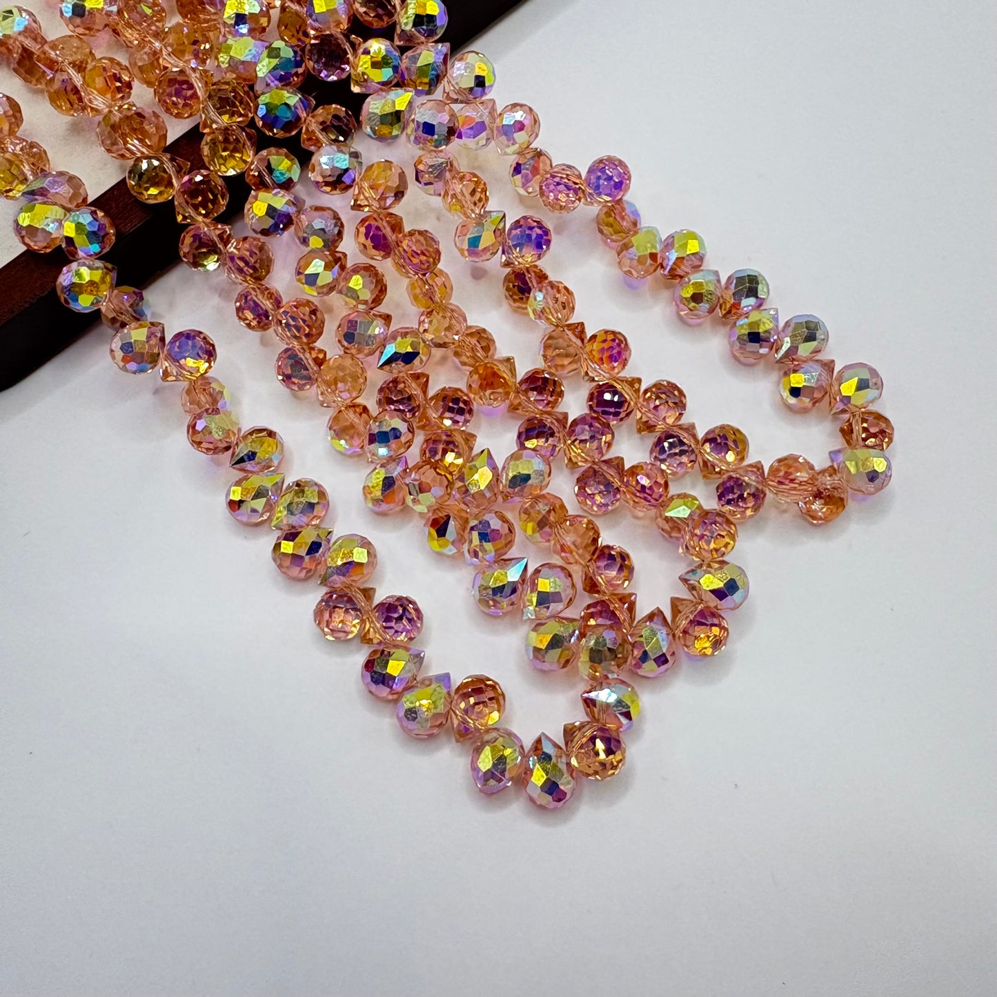 Peach AB 058 fine-cut teardrop bead strand