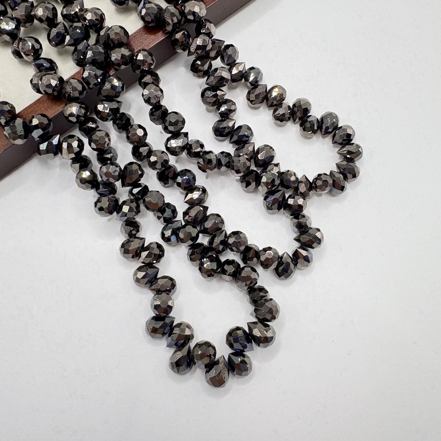 Black 064 fine-cut teardrop bead strand