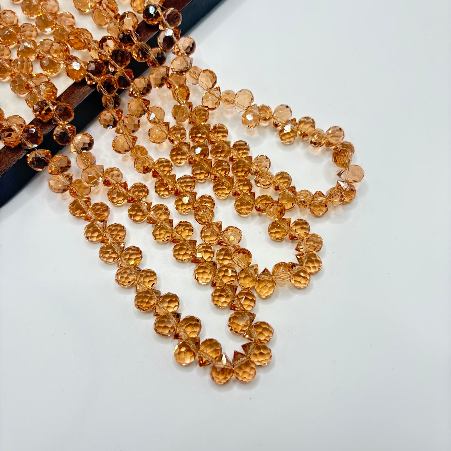 Amber 066 fine-cut teardrop bead strand