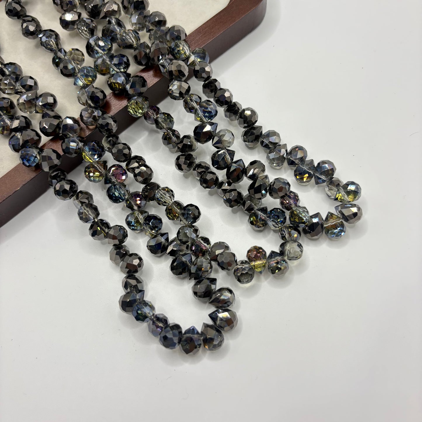 Charcoal 070 fine-cut teardrop bead strand