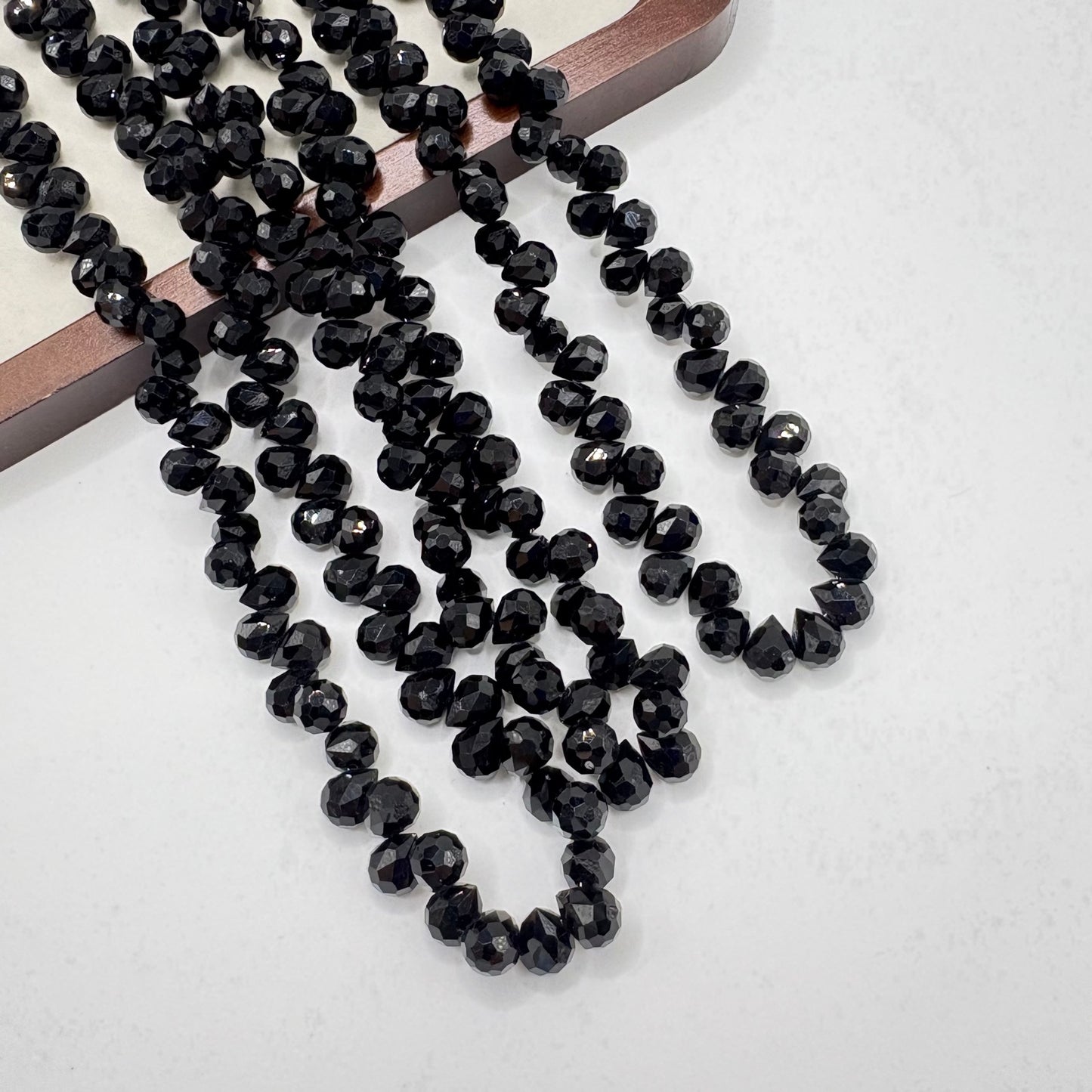 Jet Black 075 fine-cut teardrop bead strand