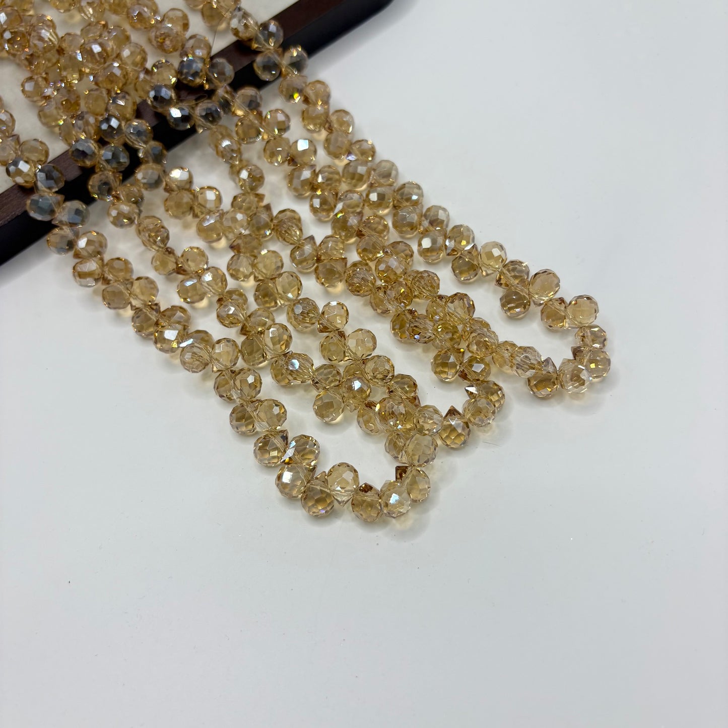 Champagne 102 fine-cut teardrop bead strand
