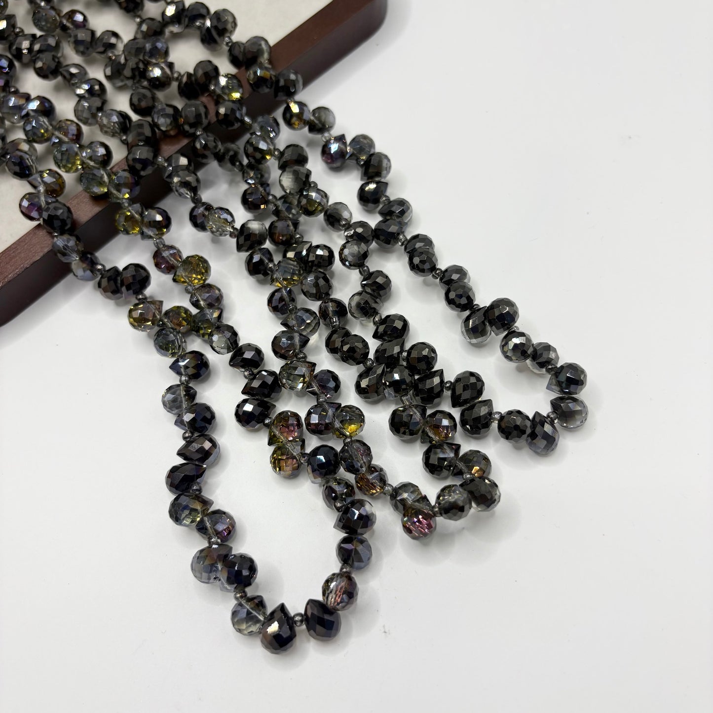 Black Smoke 109 fine-cut teardrop bead strand
