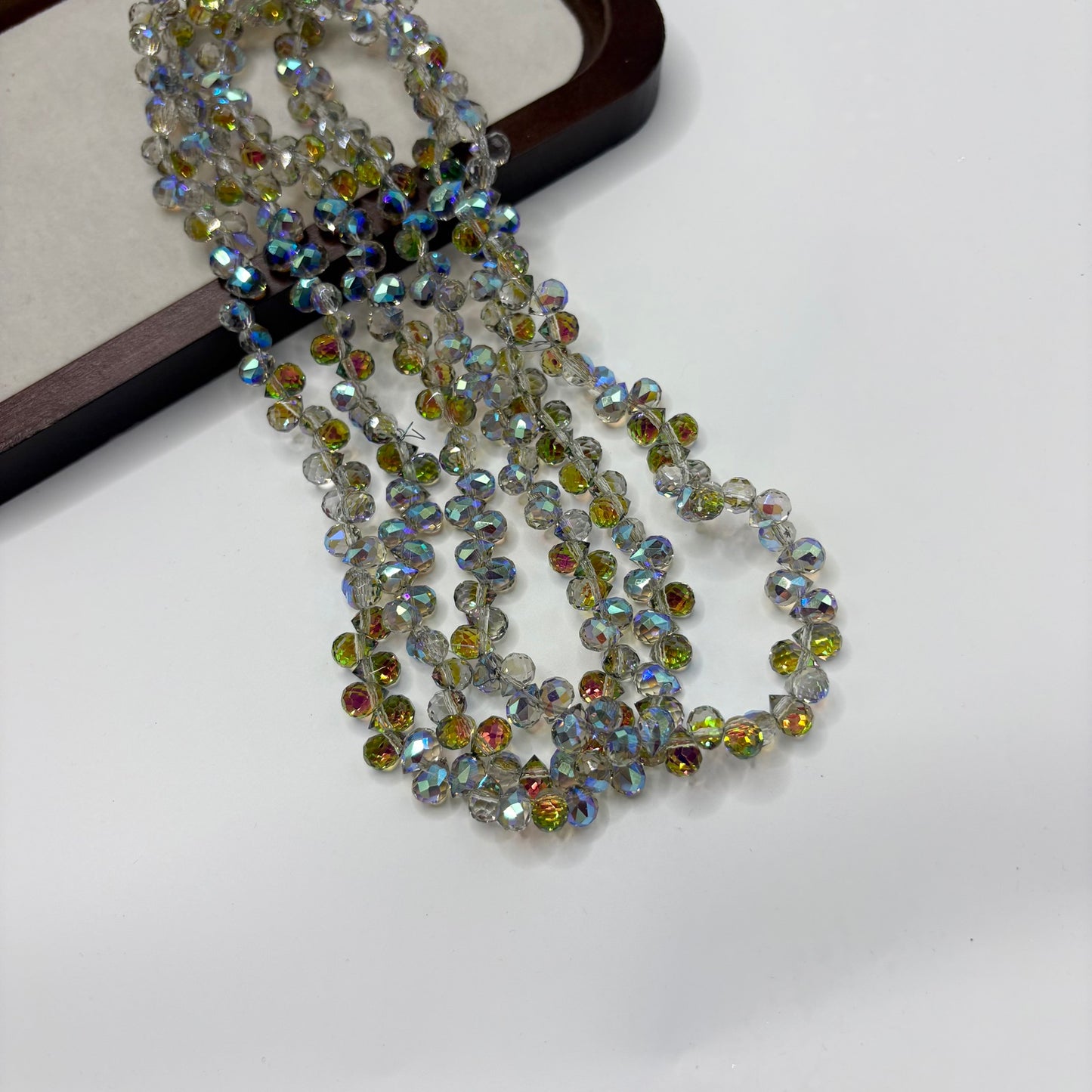 Iridescent Blue Green 112 fine-cut teardrop bead strand